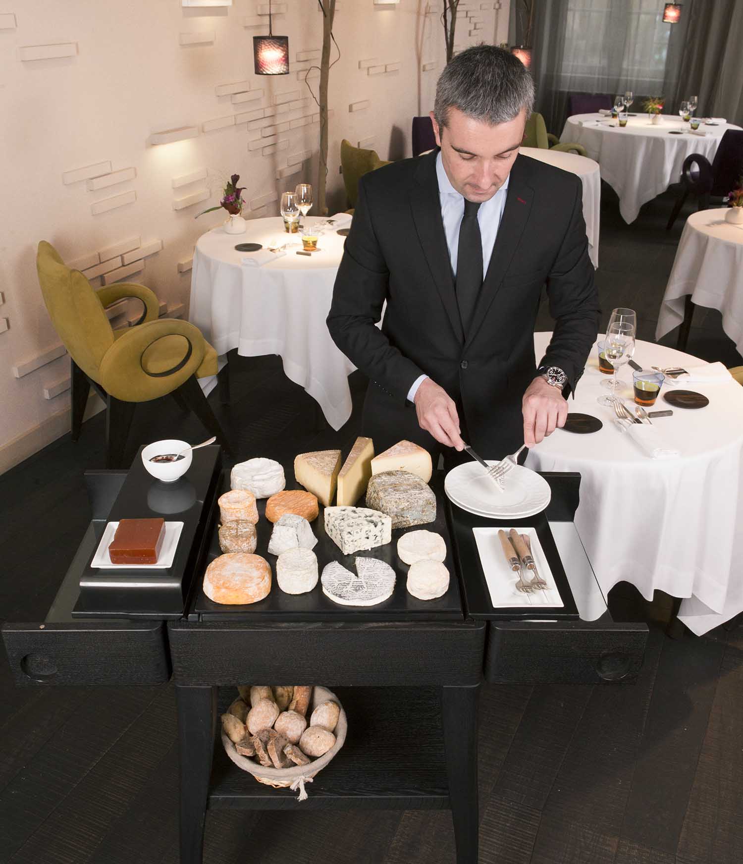 QUISO black beech KEZA cheese trolley used for cheese service by a waiter in the Lou Look restaurant, 2014